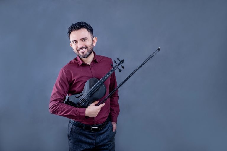 Eduardo Bortolotti standing with violin